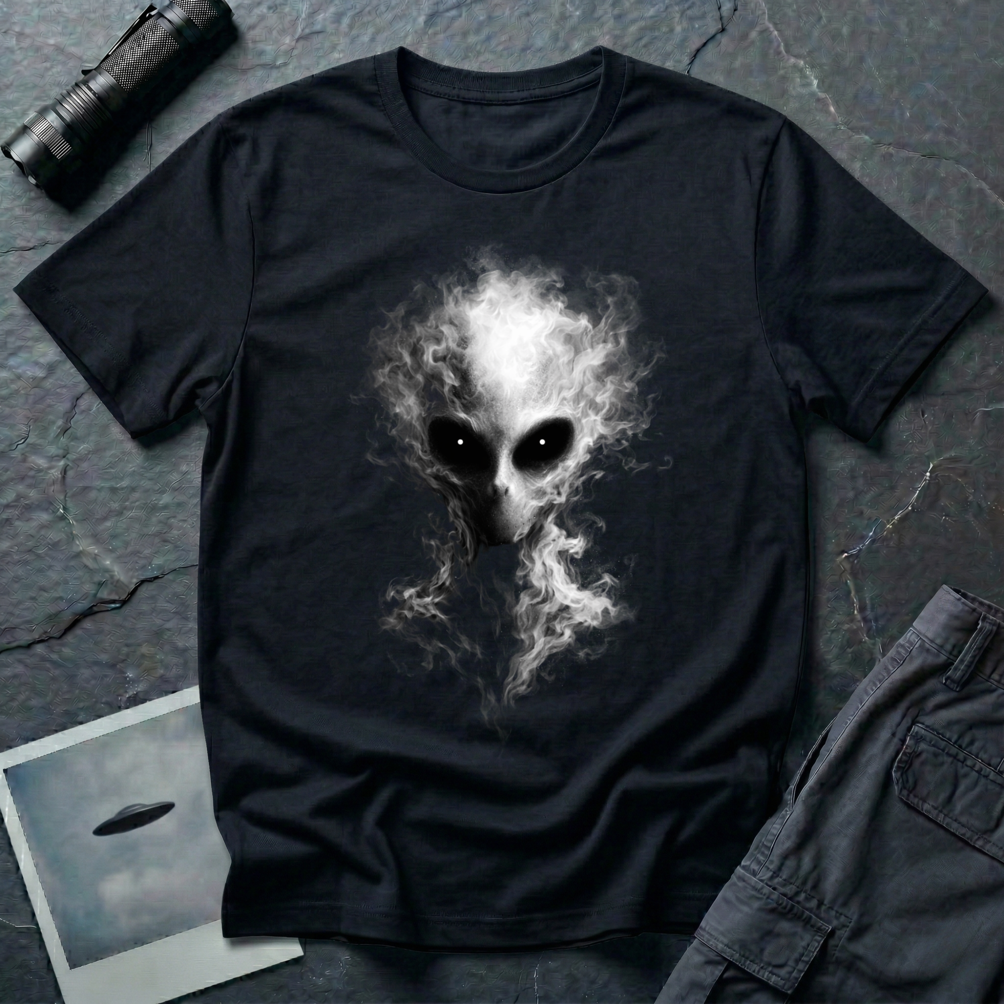 lien Smoke smoke alien t-shirt — grey alien face formed from curling white smoke wisps with dark solid eyes on black cotton tee