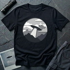 Papercut UFO t-shirt — layered paper-craft illustration of flying saucer over mountains and clouds in grey monochrome on black cotton tee
