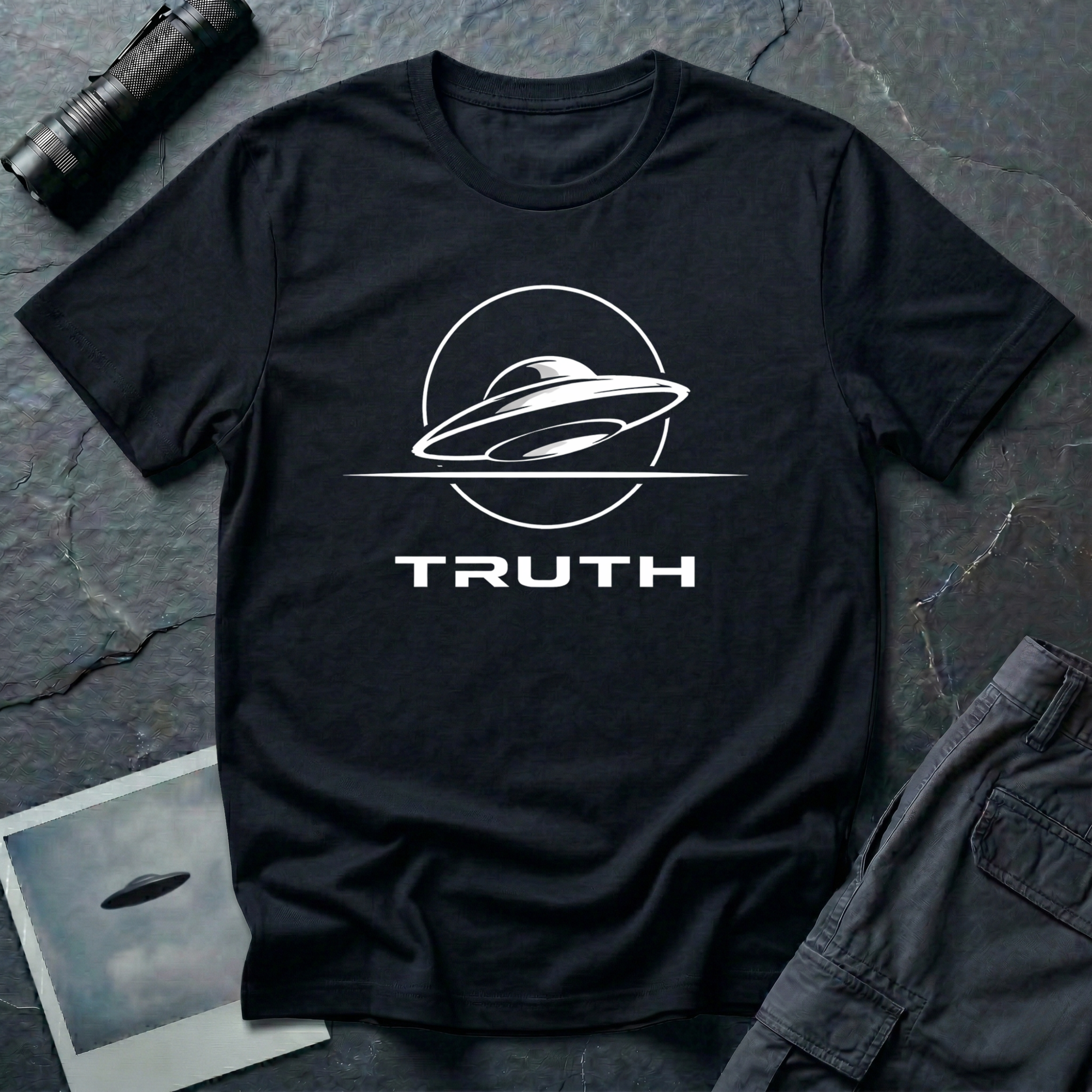 Truth UAP t-shirt — minimalist flying saucer emblem with the word TRUTH on black unisex cotton tee