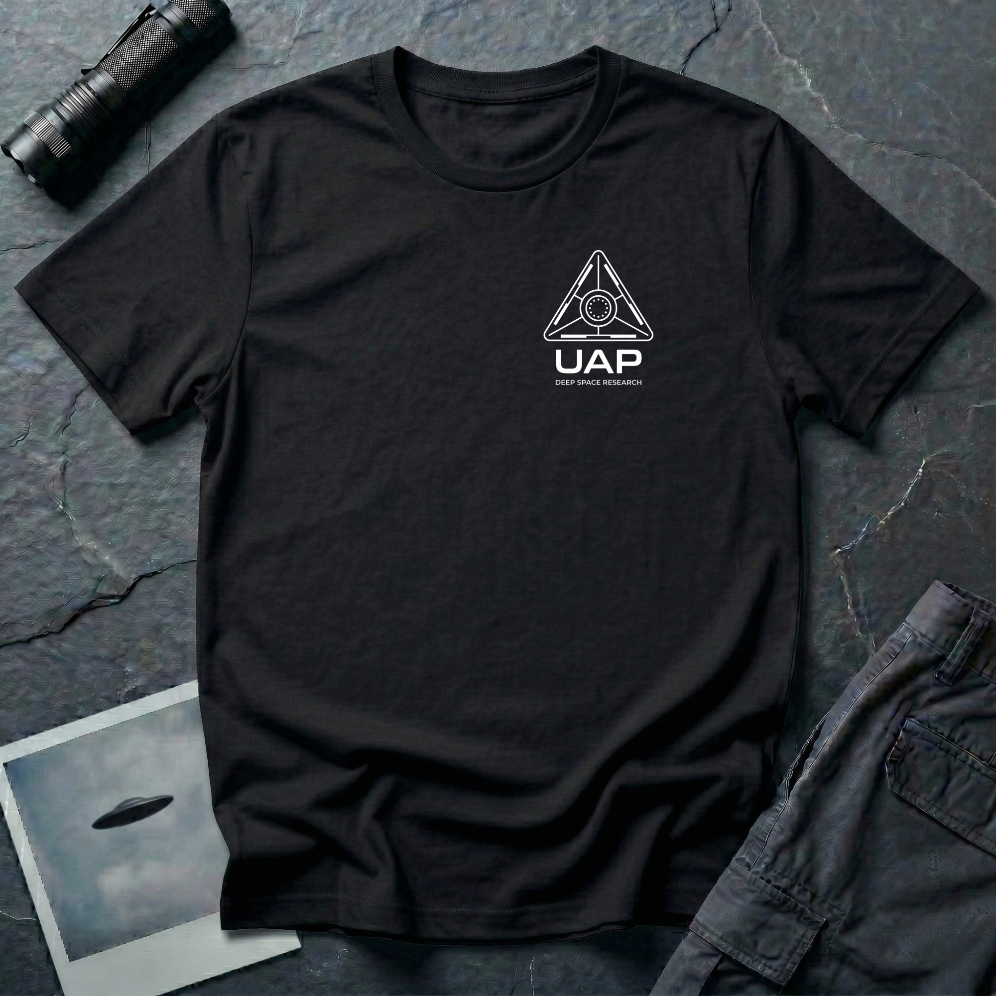 Black t-shirt with small left-chest white line art geometric triangle UAP mission patch design with the text UAP DEEP SPACE RESEARCH