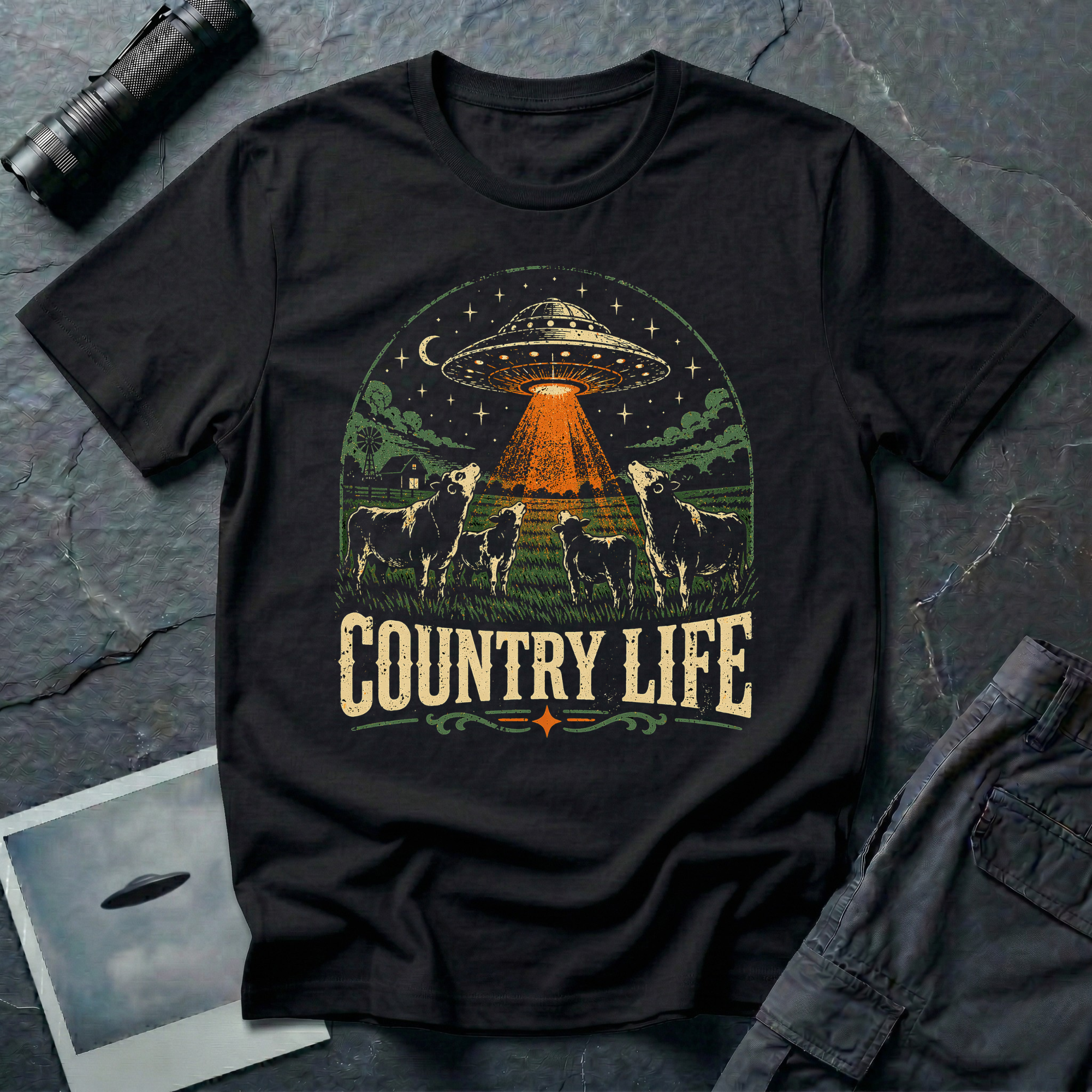 Country Life cow UFO t-shirt — flying saucer over farmyard with cattle on black unisex cotton tee
