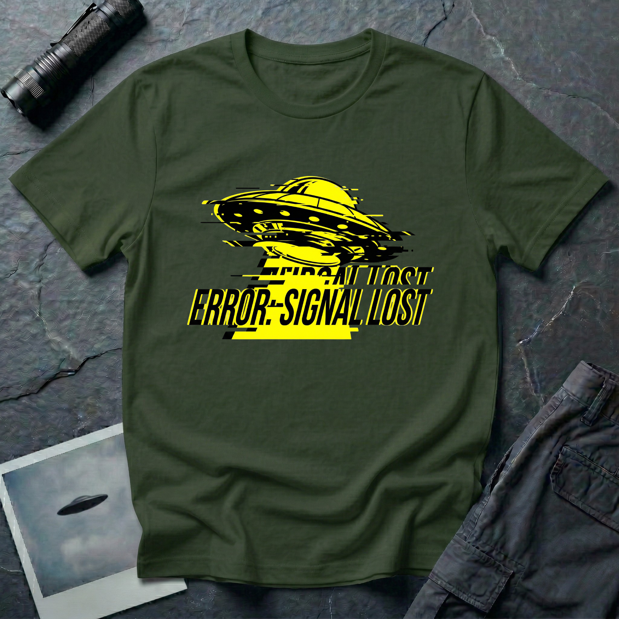 Error: Signal Lost hazard UFO t-shirt — classic flying saucer in hazard yellow and black with horizontal glitch bars and "ERROR: SIGNAL LOST" caption on green cotton tee