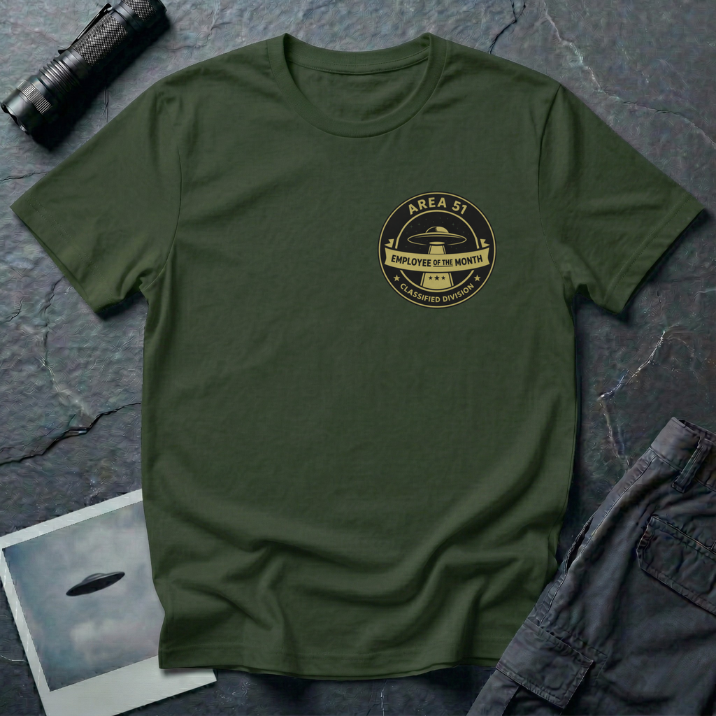 Area 51 Employee Of The Month UFO t-shirt — vintage circular badge with classic flying saucer, "Area 51" and "Classified Division" arc text, "Employee of the Month" ribbon banner in olive and black on upper-left chest of green cotton tee