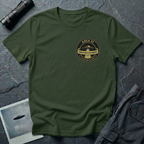 Area 51 Employee Of The Month UFO t-shirt — vintage circular badge with classic flying saucer, "Area 51" and "Classified Division" arc text, "Employee of the Month" ribbon banner in olive and black on upper-left chest of green cotton tee