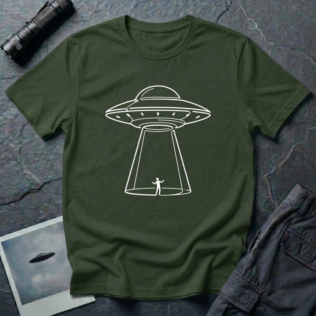 One Line UFO minimalist line art t-shirt — hand-drawn flying saucer beaming down over a tiny stick figure in one continuous white line on military green cotton tee