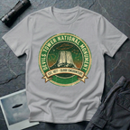 Devils Tower UFO t-shirt — vintage distressed National Park badge with the Wyoming monument silhouette, tiny flying saucers and constellations over a starry green sky, "DEVILS TOWER NATIONAL MONUMENT" arc text and "EST. 1906 — CLOSE ENCOUNTERS" banner on grey cotton tee