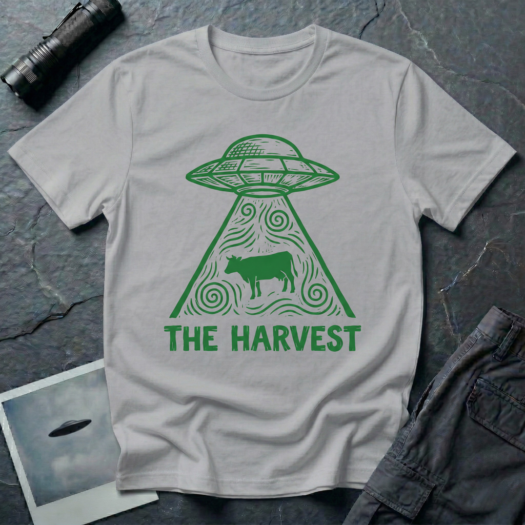 The Harvest dark folklore UFO t-shirt — linocut flying saucer with swirling beam abducting a lone cow in green on grey cotton tee
