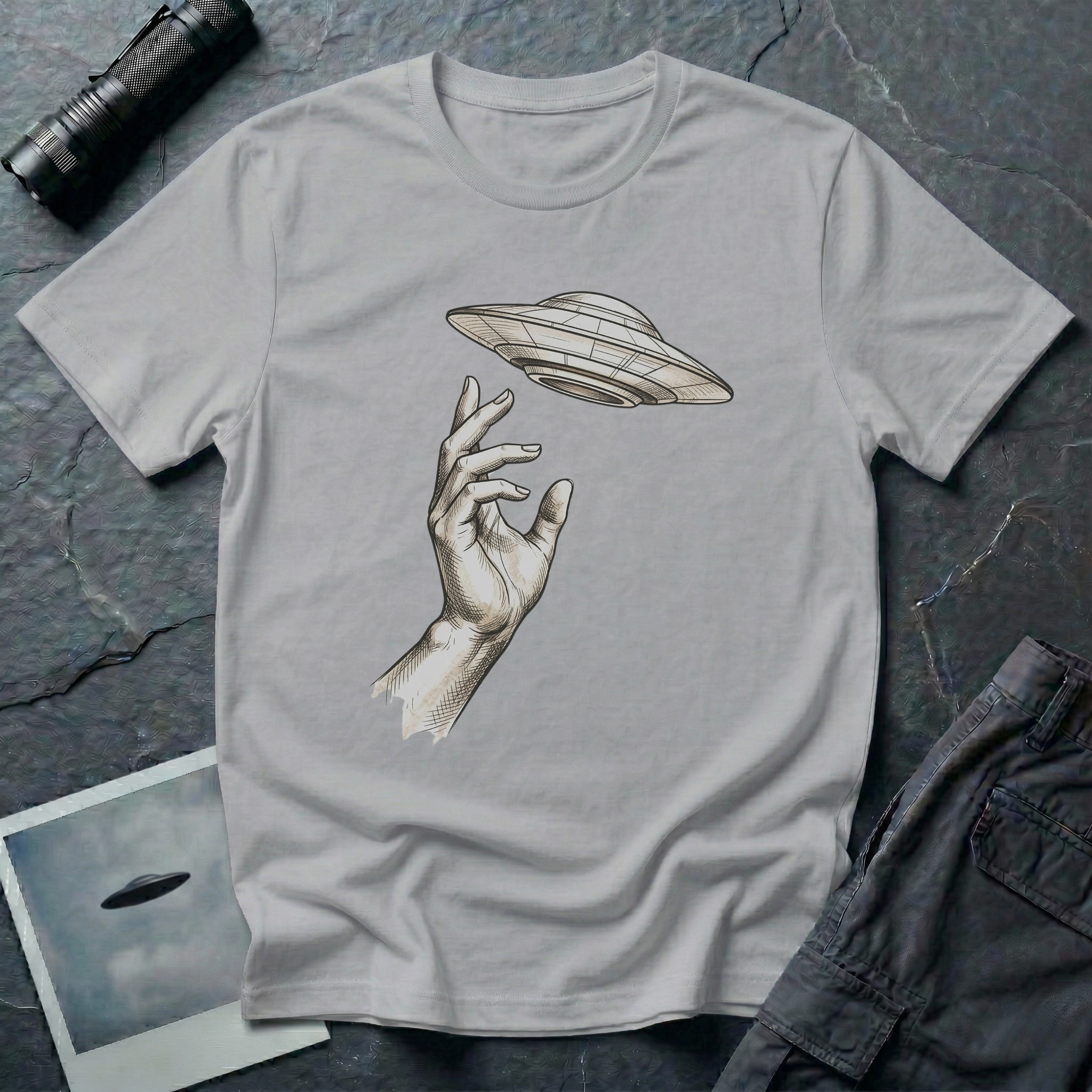 Da Vinci's UFO Renaissance t-shirt — classical ink sketch of a hand reaching for a flying saucer on grey unisex cotton tee
