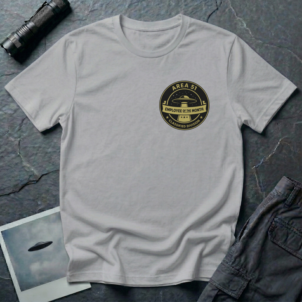 Area 51 Employee Of The Month UFO t-shirt — vintage circular badge with classic flying saucer, "Area 51" and "Classified Division" arc text, "Employee of the Month" ribbon banner in olive and black on upper-left chest of grey cotton tee