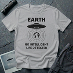No Intelligent Life Detected UFO t-shirt — classic flying saucer above concentric scan rings and crosshairs targeting Earth with "EARTH / NO INTELLIGENT LIFE DETECTED" caption in black on grey cotton tee