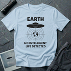 No Intelligent Life Detected UFO t-shirt — classic flying saucer above concentric scan rings and crosshairs targeting Earth with "EARTH / NO INTELLIGENT LIFE DETECTED" caption in black on light blue cotton tee