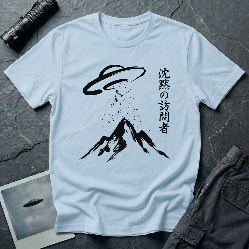 The Silent Visitor sumi-e UFO t-shirt — brush-painted flying saucer over mountain peak with Japanese "silent visitor" calligraphy on light blue cotton tee