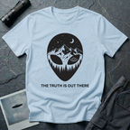 The Truth Is Out There alien head t-shirt — alien silhouette filled with mountains, pine forest and flying saucer on light blue cotton tee