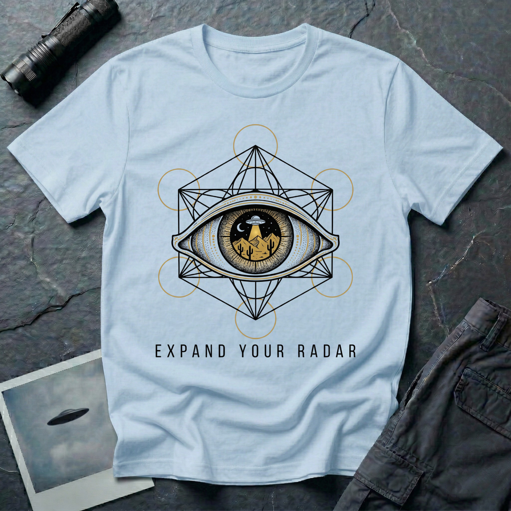 Expand Your Radar all seeing eye UFO t-shirt — sacred geometry frame around an eye containing a desert UFO encounter in gold and black linework on light blue cotton tee