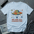 We Are All Connected folk quilt UFO t-shirt — patchwork saucer with cross-stitched fabric panels and stars in rust, navy and olive on light bluecotton tee