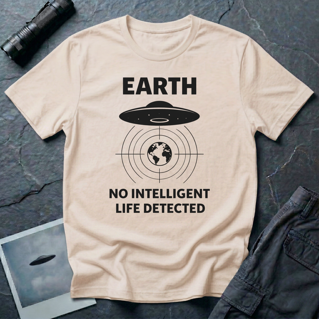 No Intelligent Life Detected UFO t-shirt — classic flying saucer above concentric scan rings and crosshairs targeting Earth with "EARTH / NO INTELLIGENT LIFE DETECTED" caption in black on natural cotton tee