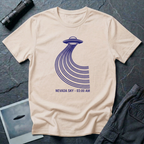 Nevada Sky 03:00 AM UFO sighting t-shirt — navy flying saucer with parabolic trail of parallel lines and timestamp caption on natural cotton tee
