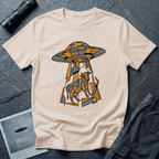 Cubist Cow geometric cow abduction t-shirt — flying saucer and suspended cow rendered in angular faceted planes of orange, grey, and white triangular geometric fragments on natural cotton tee