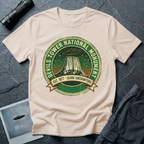 Devils Tower UFO t-shirt — vintage distressed National Park badge with the Wyoming monument silhouette, tiny flying saucers and constellations over a starry green sky, "DEVILS TOWER NATIONAL MONUMENT" arc text and "EST. 1906 — CLOSE ENCOUNTERS" banner on natural cotton tee