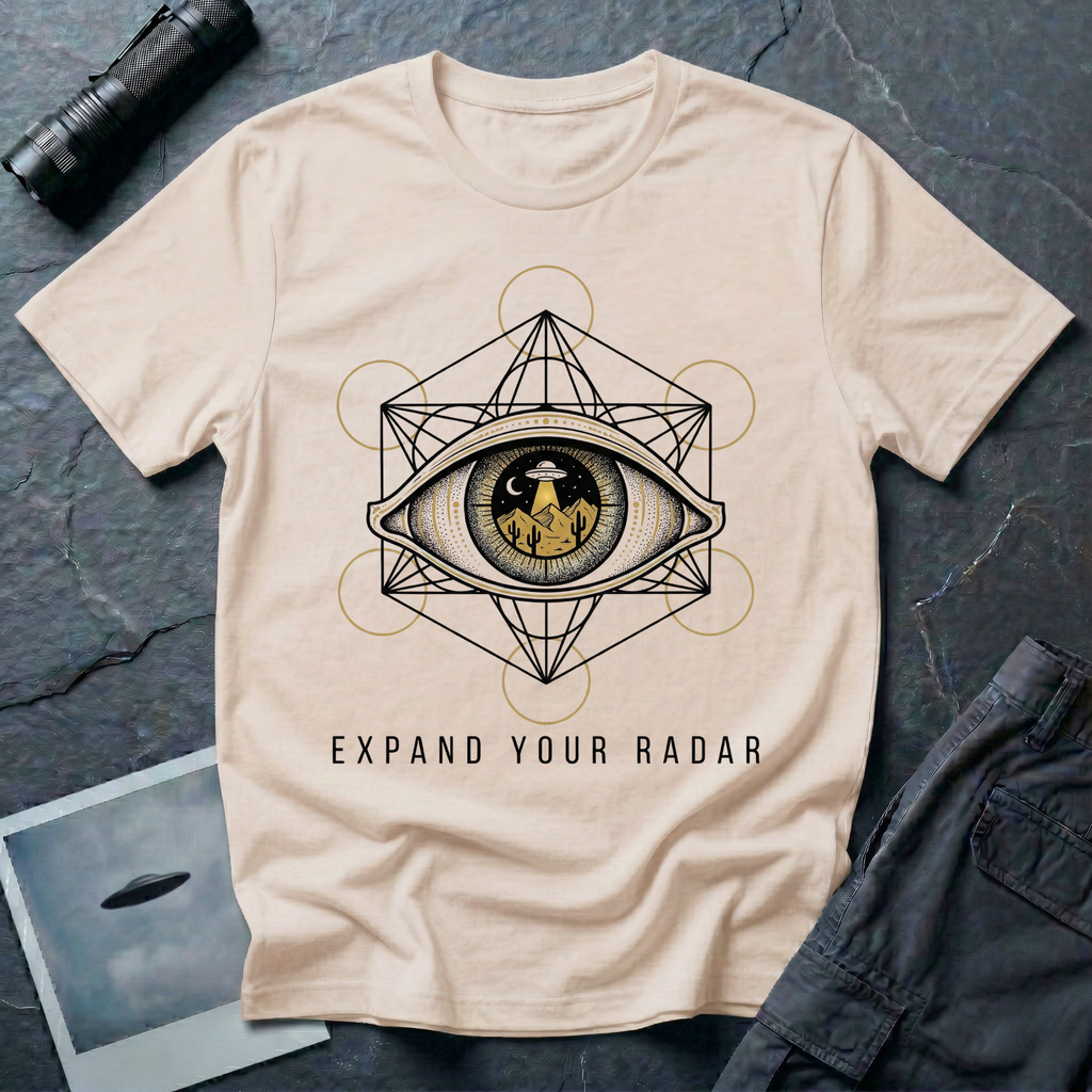 Expand Your Radar all seeing eye UFO t-shirt — sacred geometry frame around an eye containing a desert UFO encounter in gold and black linework on natural cotton tee