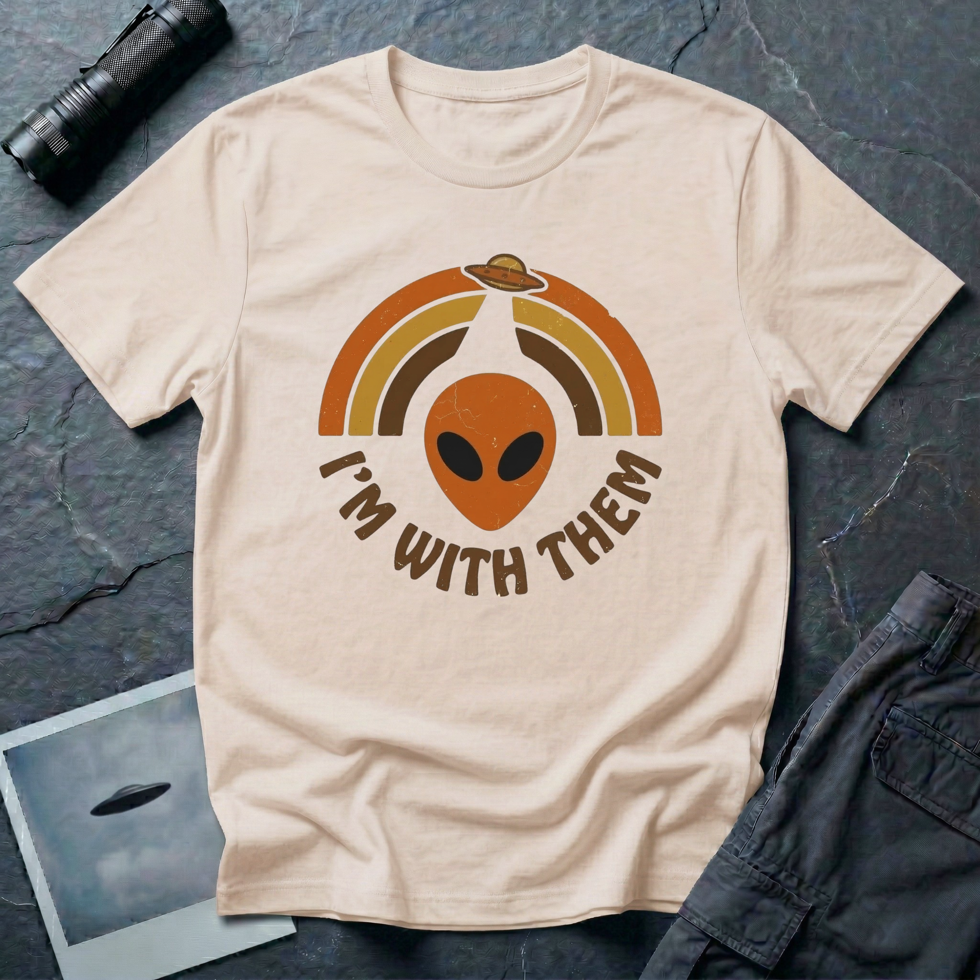 I'm With Them funny alien t-shirt — alien face with 70s sunburst arcs and ringed planet on natural unisex cotton tee