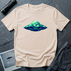 Cubist UFO geometric low poly t-shirt — classic flying saucer rendered in triangular facets of mint green, teal, and navy blue on natural cotton tee