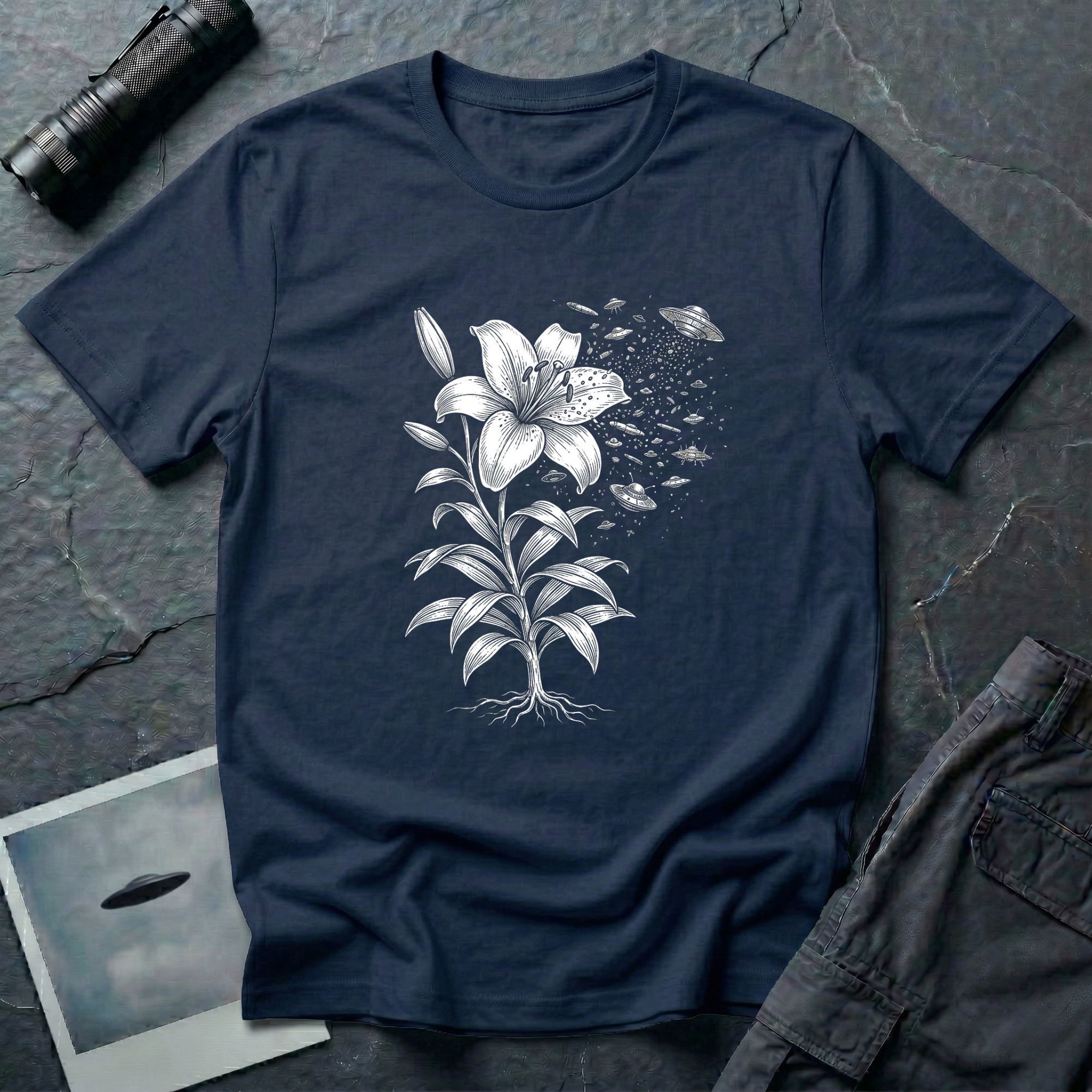 Space Lily surreal UFO art t-shirt — Victorian botanical lily illustration dissolving into flying saucers in white linework on navy cotton tee