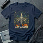 We Are Not Alone vintage UFO t-shirt — flying saucer over intricate crop circle and Flower of Life on navy unisex cotton tee
