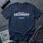 Navy blue t-shirt with PROJECT ASCENSION UAP TEST DIVISION military stencil lettering in white and blue with winged delta emblem