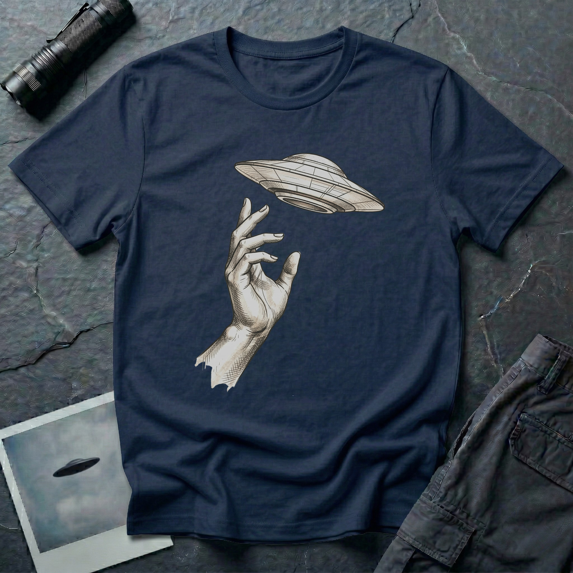 Da Vinci's UFO Renaissance t-shirt — classical ink sketch of a hand reaching for a flying saucer on navy unisex cotton tee