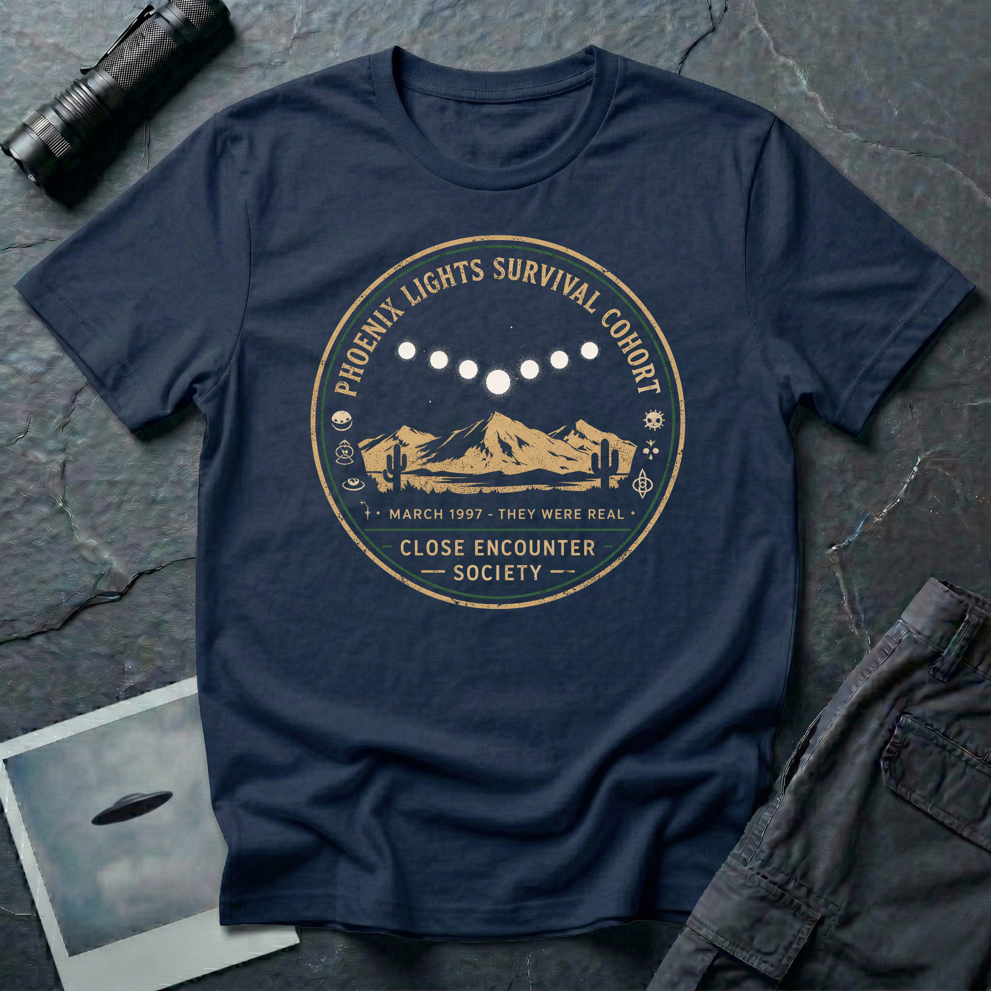 Phoenix Lights Survival Cohort UFO t-shirt — vintage badge design with seven-light formation over Arizona desert on navy unisex cotton tee