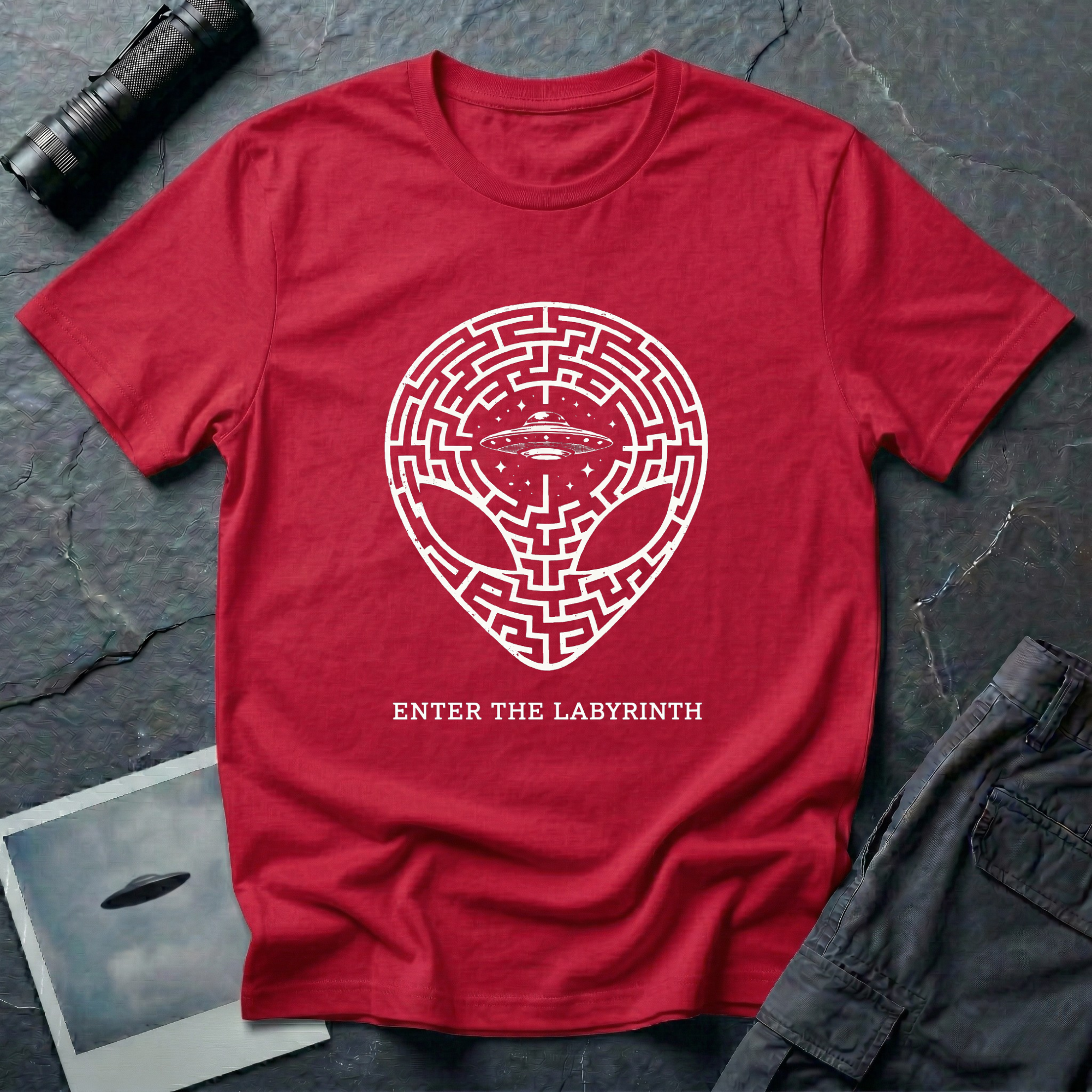 Enter The Labyrinth esoteric alien t-shirt — grey alien head filled with maze pattern and a flying saucer at the third eye in cream line-work on red cotton tee