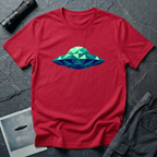 Cubist UFO geometric low poly t-shirt — classic flying saucer rendered in triangular facets of mint green, teal, and navy blue on red cotton tee