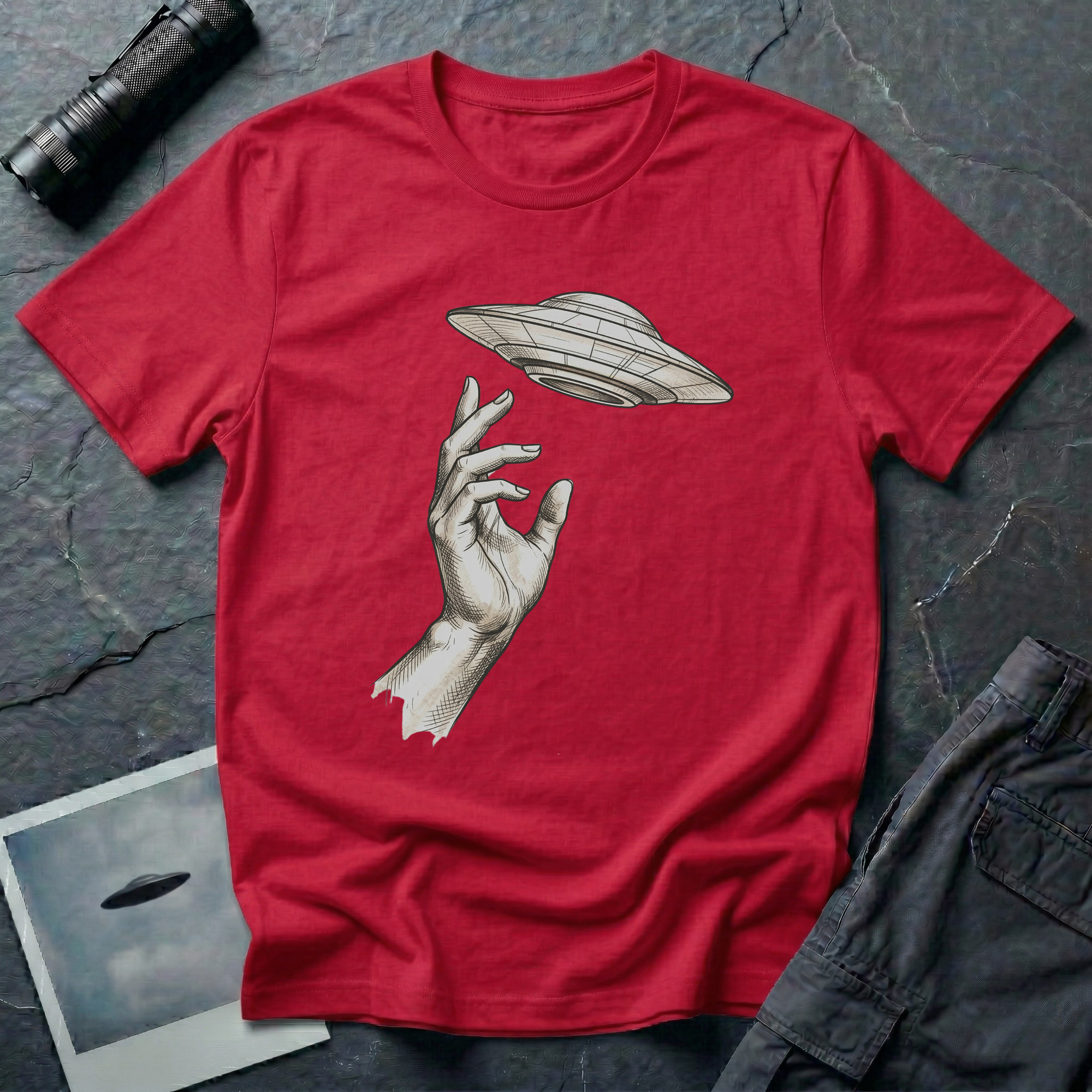 Da Vinci's UFO Renaissance t-shirt — classical ink sketch of a hand reaching for a flying saucer on red unisex cotton tee