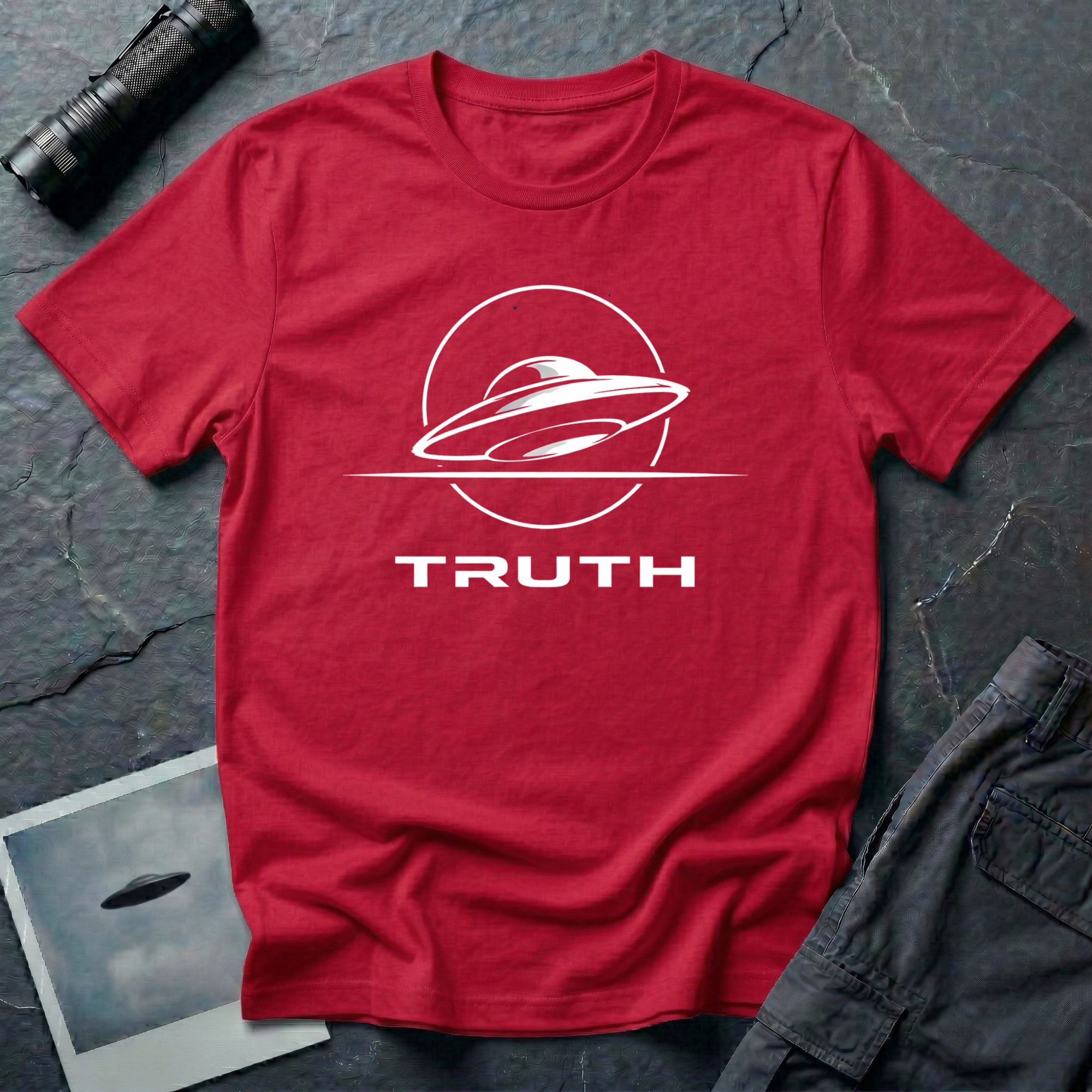 Truth UAP t-shirt — minimalist flying saucer emblem with the word TRUTH on red unisex cotton tee