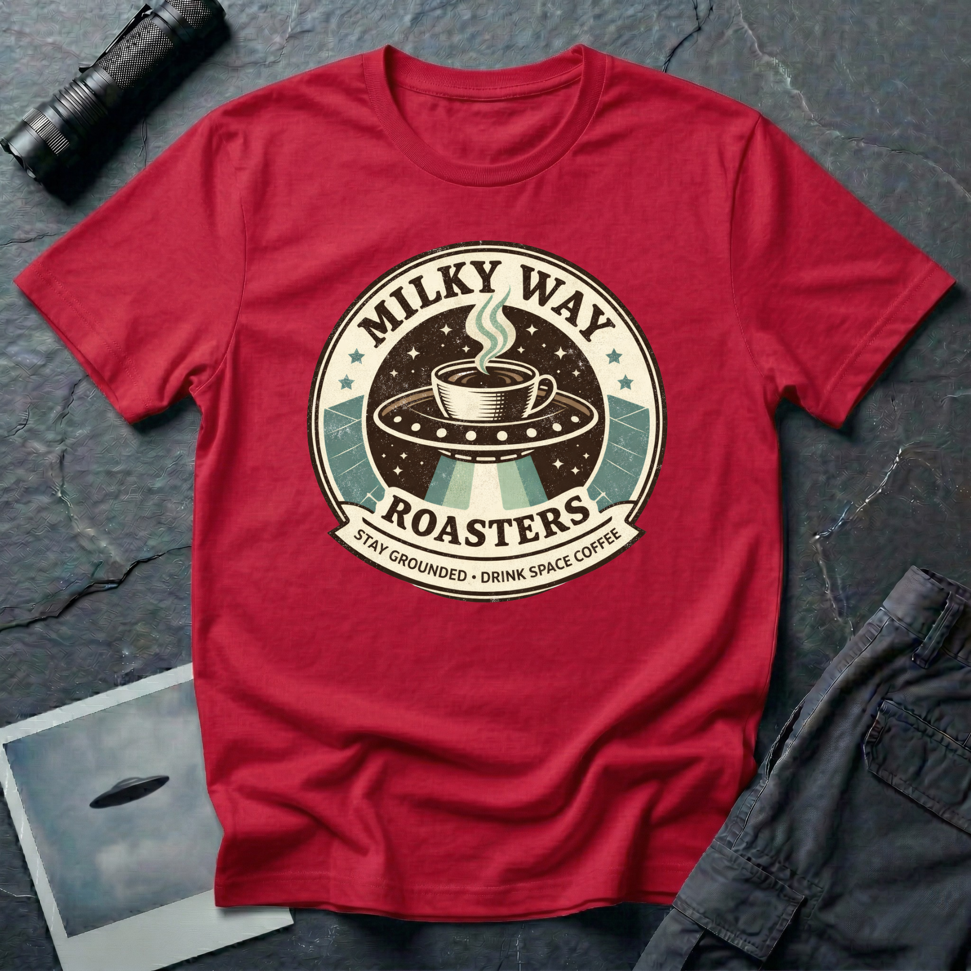 Milky Way Roasters coffee UFO t-shirt — vintage roaster badge with steaming cup on flying saucer and "Stay Grounded Drink Space Coffee" tagline on red cotton tee