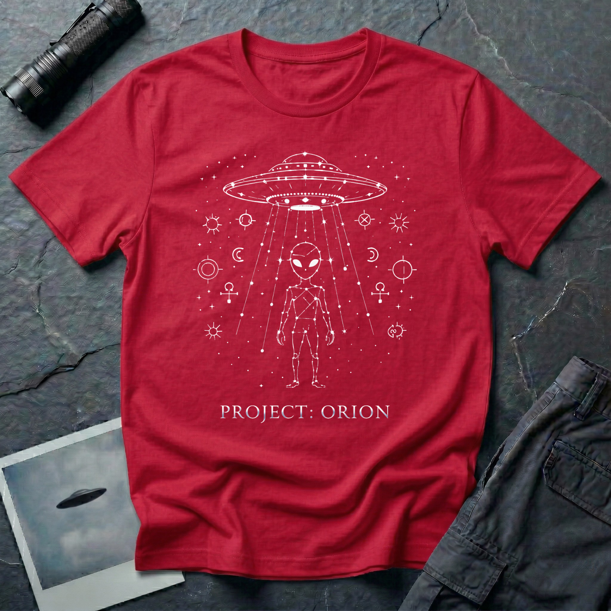 Project Orion experiencer UFO t-shirt — humanoid figure drawn as constellation with flying saucer above and esoteric sigils in white linework on red cotton tee