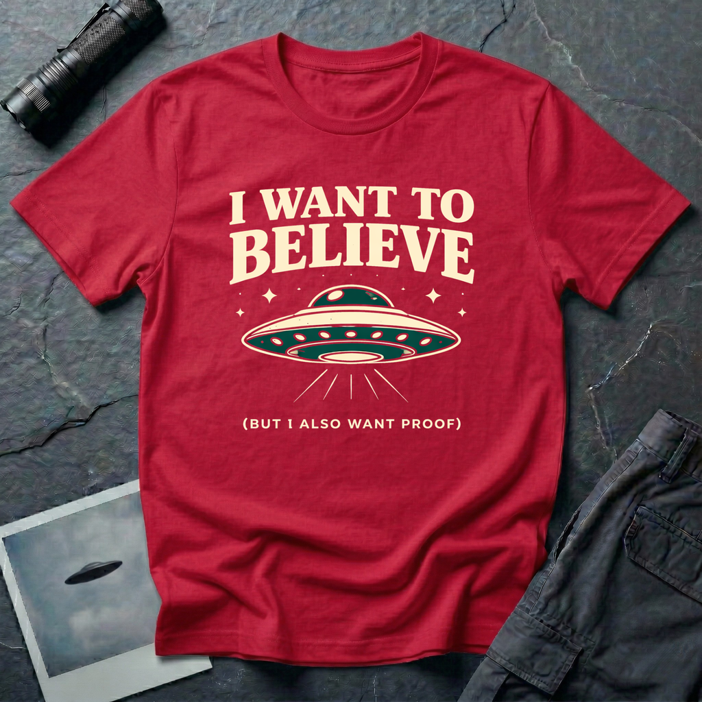 I Want To Believe ironic UFO t-shirt — classic teal saucer with the phrase "I want to believe (but I also want proof)" on red cotton tee