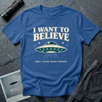 I Want To Believe ironic UFO t-shirt — classic teal saucer with the phrase "I want to believe (but I also want proof)" on blue cotton tee