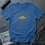 Orbit astronomical UFO t-shirt — flying saucer centred in a gold orbital sphere framework with "Ørbit" sans serif typography on royal blue cotton tee