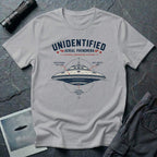 Grey t-shirt with military-style UAP Reverse Engineering Division patch featuring an annotated saucer diagram with gravitational flux core anti-inertia ring and plasma propulsion vents callouts