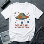 We Are All Connected folk quilt UFO t-shirt — patchwork saucer with cross-stitched fabric panels and stars in rust, navy and olive on white cotton tee
