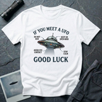 If You Meet A UFO funny UFO t-shirt — flying saucer with deadpan safety instructions on white unisex cotton tee
