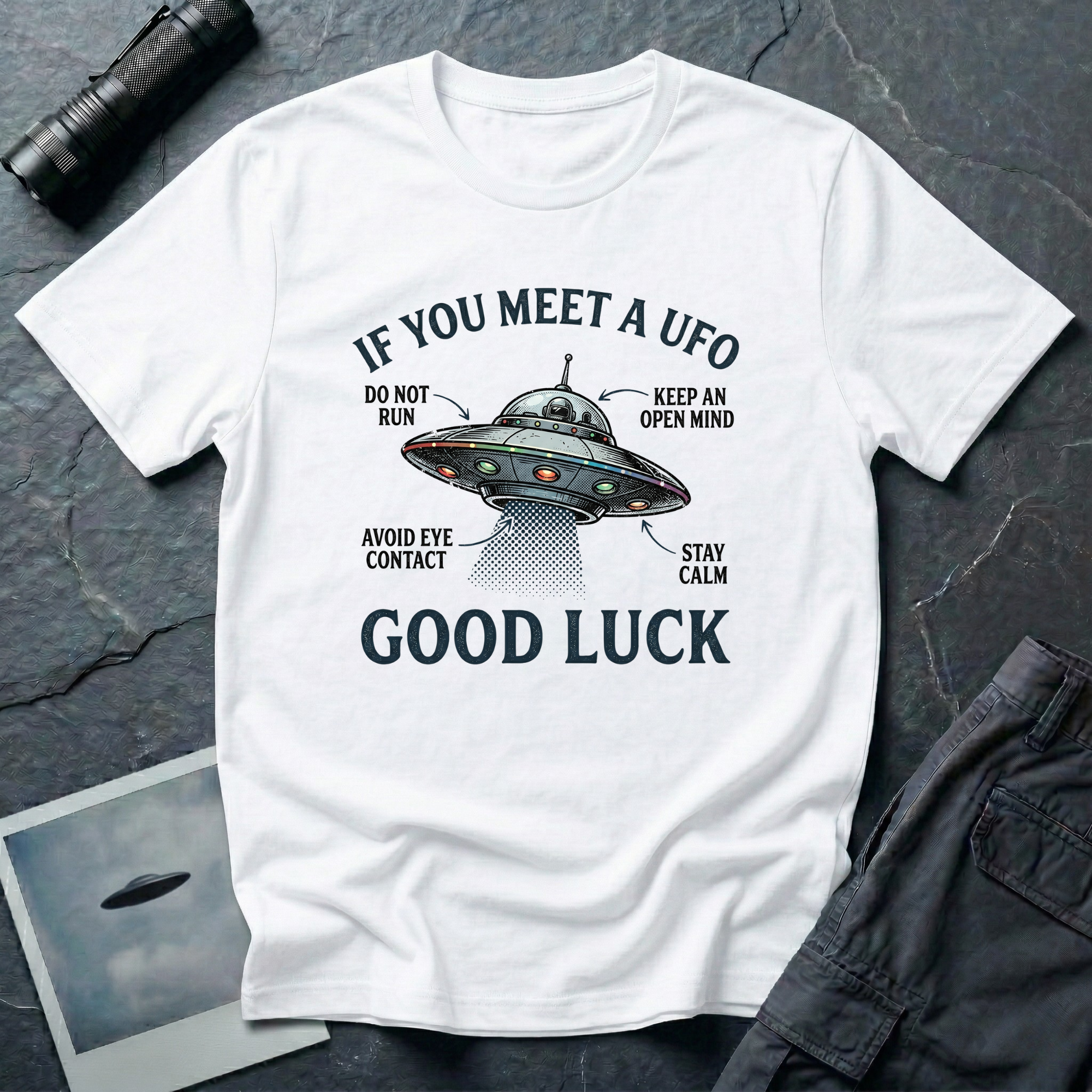 If You Meet A UFO funny UFO t-shirt — flying saucer with deadpan safety instructions on white unisex cotton tee