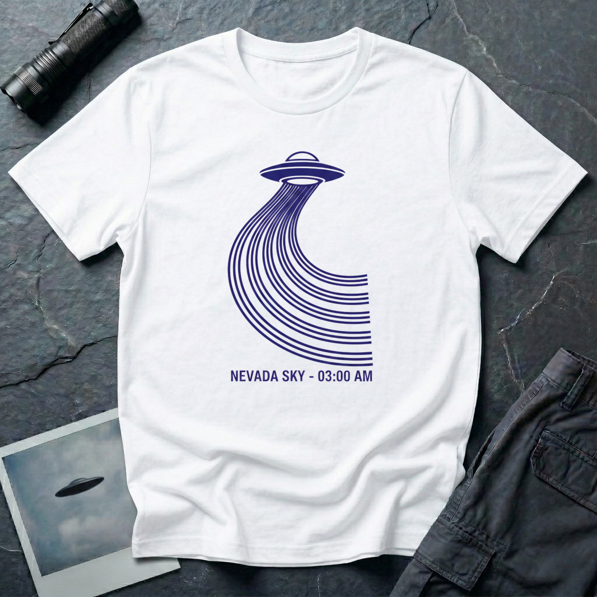 Nevada Sky 03:00 AM UFO sighting t-shirt — navy flying saucer with parabolic trail of parallel lines and timestamp caption on white cotton tee
