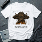 The Wicker Visit folk horror UFO t-shirt — woven wicker flying saucer with antler crown burning in orange flames on white cotton tee