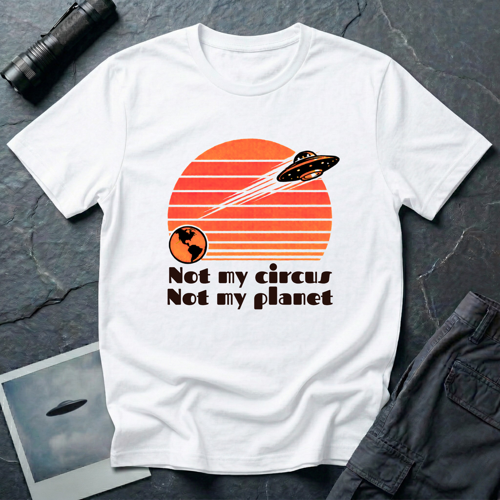 Not My Circus retro 1970s UFO t-shirt — flying saucer leaving Earth against striped sunset with "not my circus, not my planet" type on white unisex cotton tee
