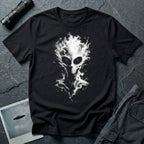 Alien t-shirt laid flat on a dark textured surface, featuring a large white and gray alien head made of smoke, with glowing eyes, black