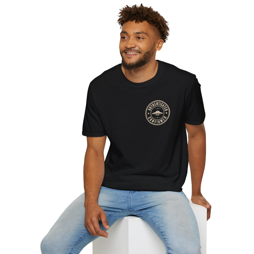 Man wearing black UFO t-shirt with a small distressed circular badge on the left chest showing a flying saucer and the words AUTHENTICATED CONFIRMED in cream white