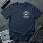 Navy blue UFO t-shirt with a small distressed circular badge on the left chest showing a flying saucer and the words AUTHENTICATED CONFIRMED in cream white